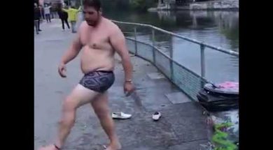 Drunk Guy Tries To Jump Over Railing Into River Below